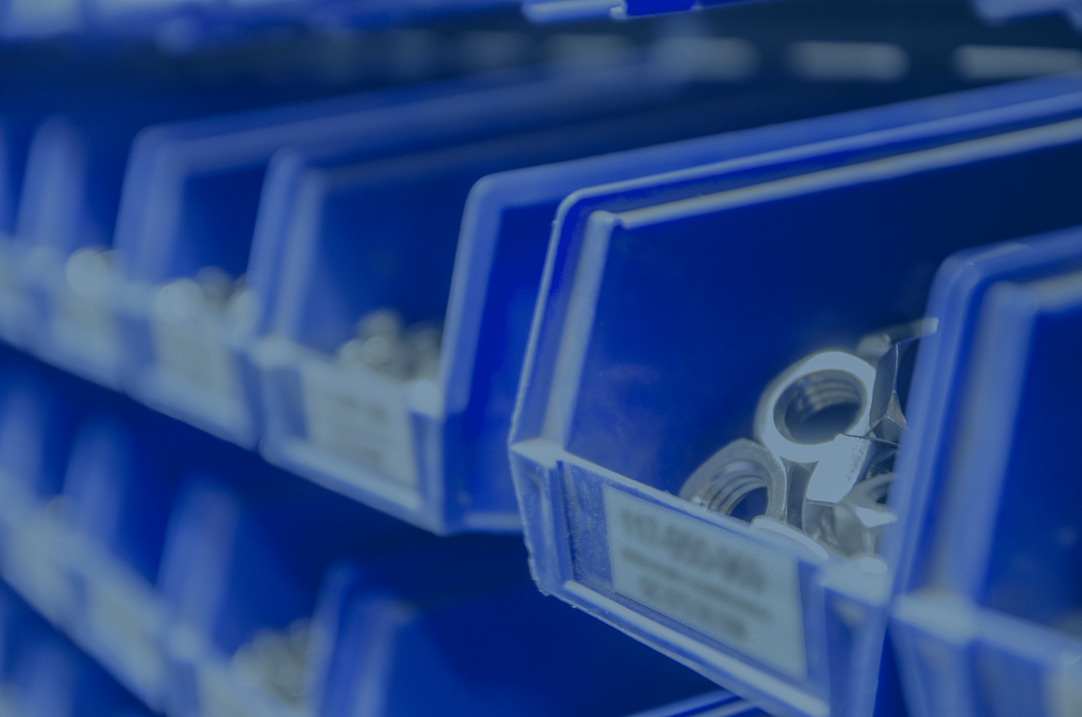 Stock inventory blue bins with hex nuts with blue overlay